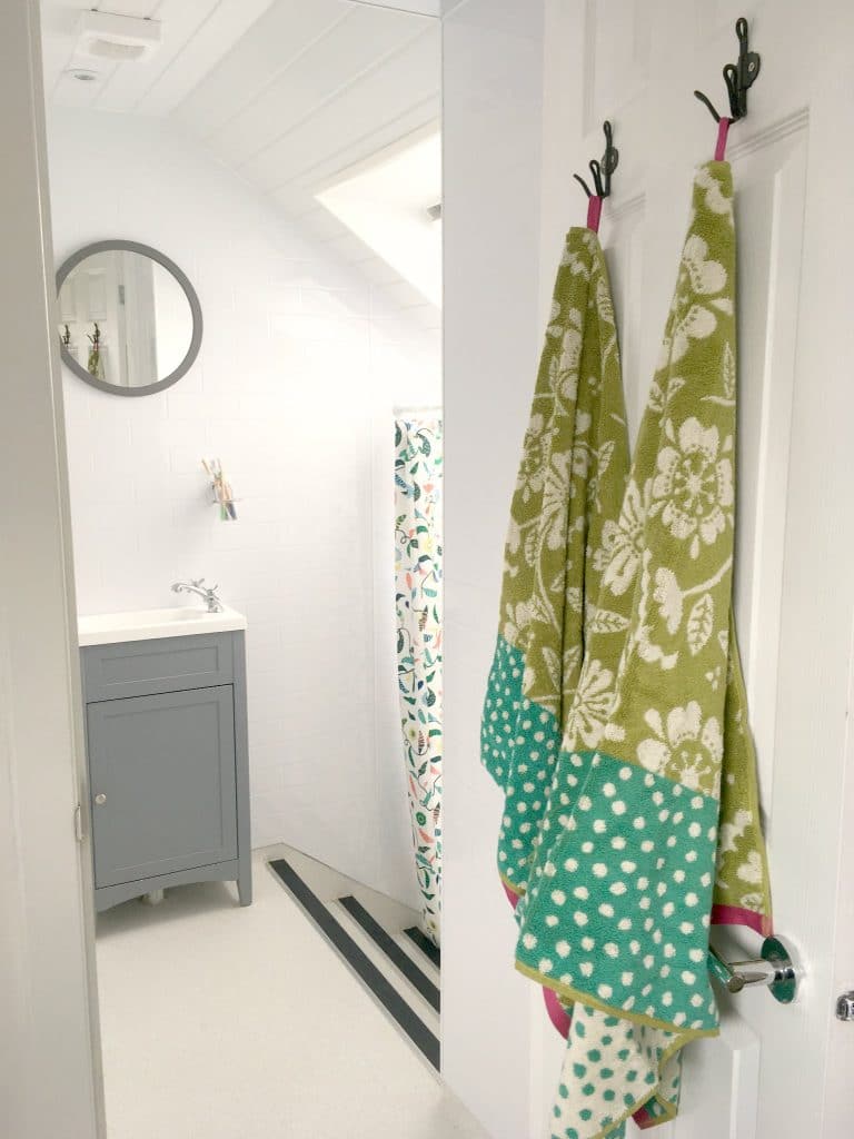 gudrun sjoden green organic towels hanging in white bathroom