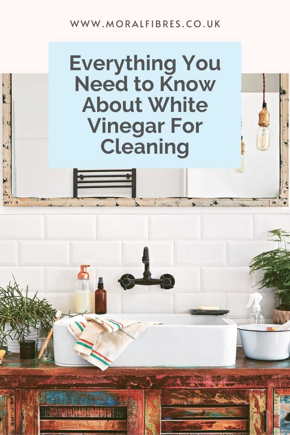 White bathroom with a blue text box that reads Everything You Need to Know About White Vinegar For Natural Cleaning