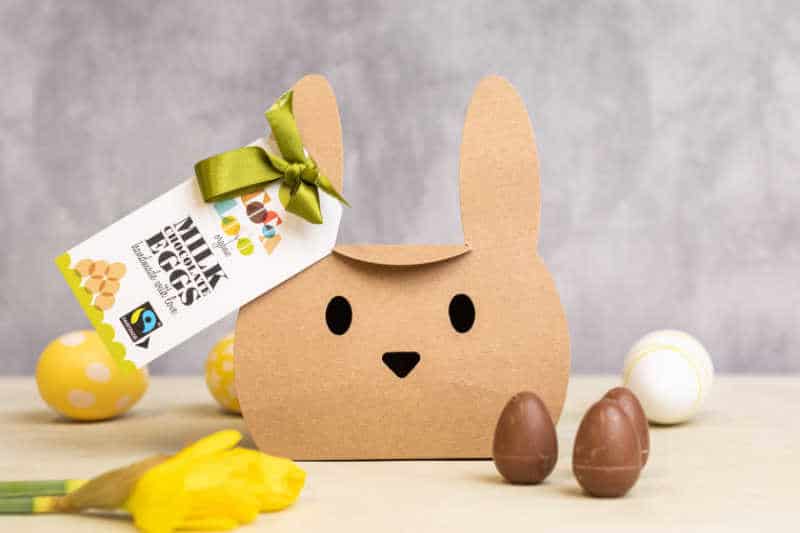 Cardboard box in the shape of a bunny with chocolate eggs.