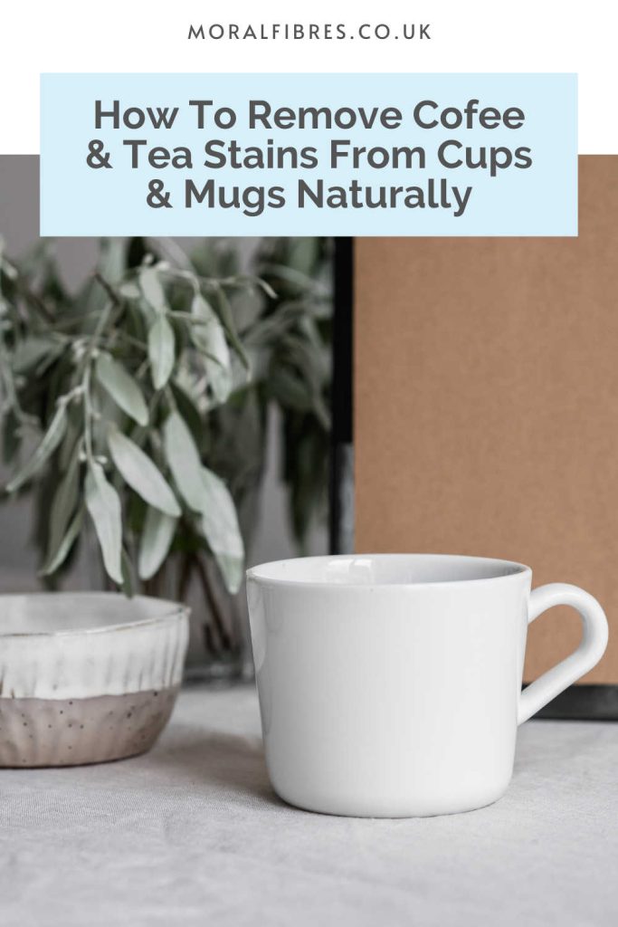 White cup next to a plant with blue text box that reads how to remove coffee and tea stains from cups and mugs naturally.