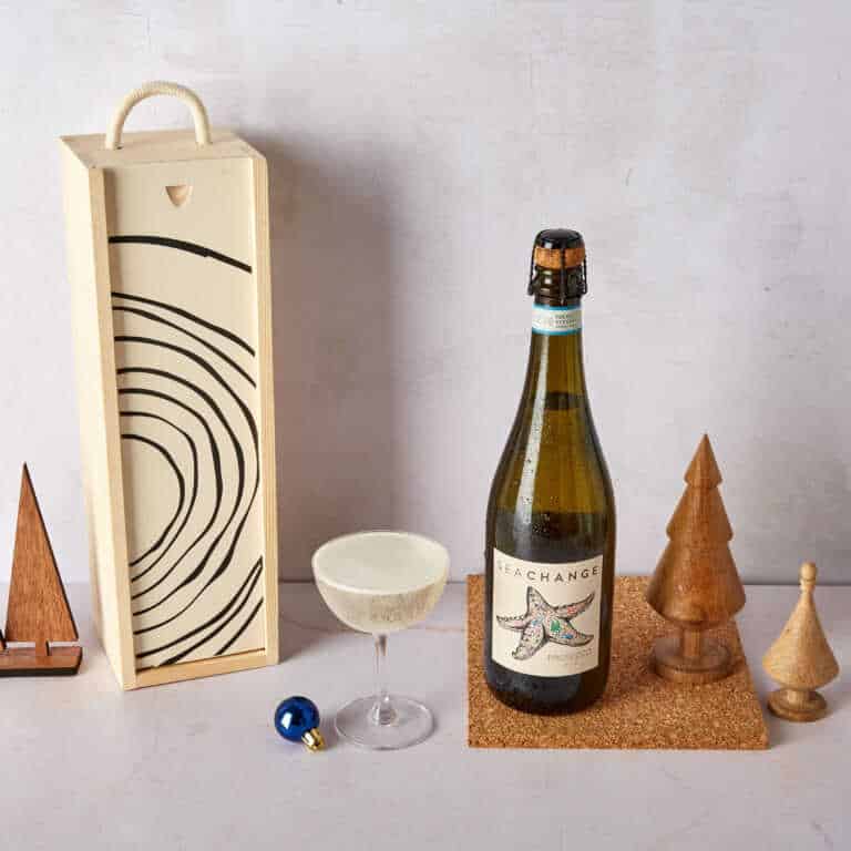 Bottle of Sea Change wine in a sustainable wooden gift box, and surrounded by Christmas decorations.