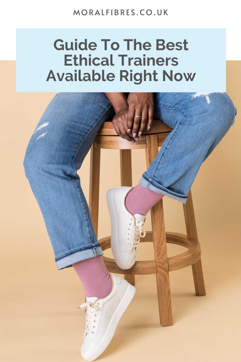 Person sitting on a chair, wearing jeans and trainers, with a blue text box that reads guide to the best ethical trainers. 
