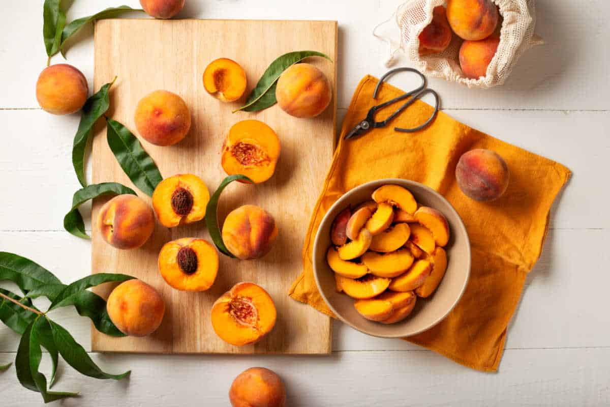 Sliced peaches on a wooden chopping board