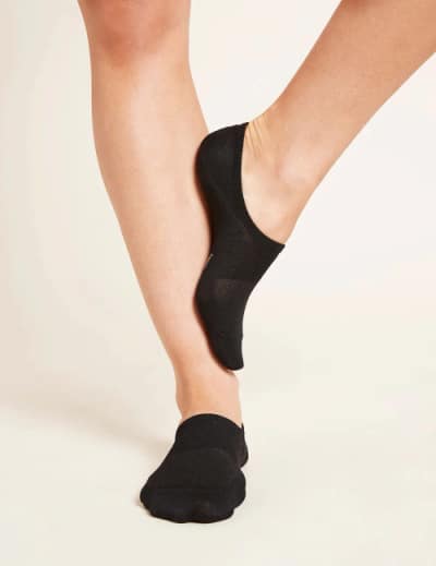 Person wearing black trainer socks from Boody.