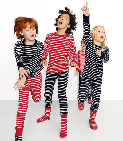 Three kids wearing sustainable stripes clothing from Polarn O Pyret.
