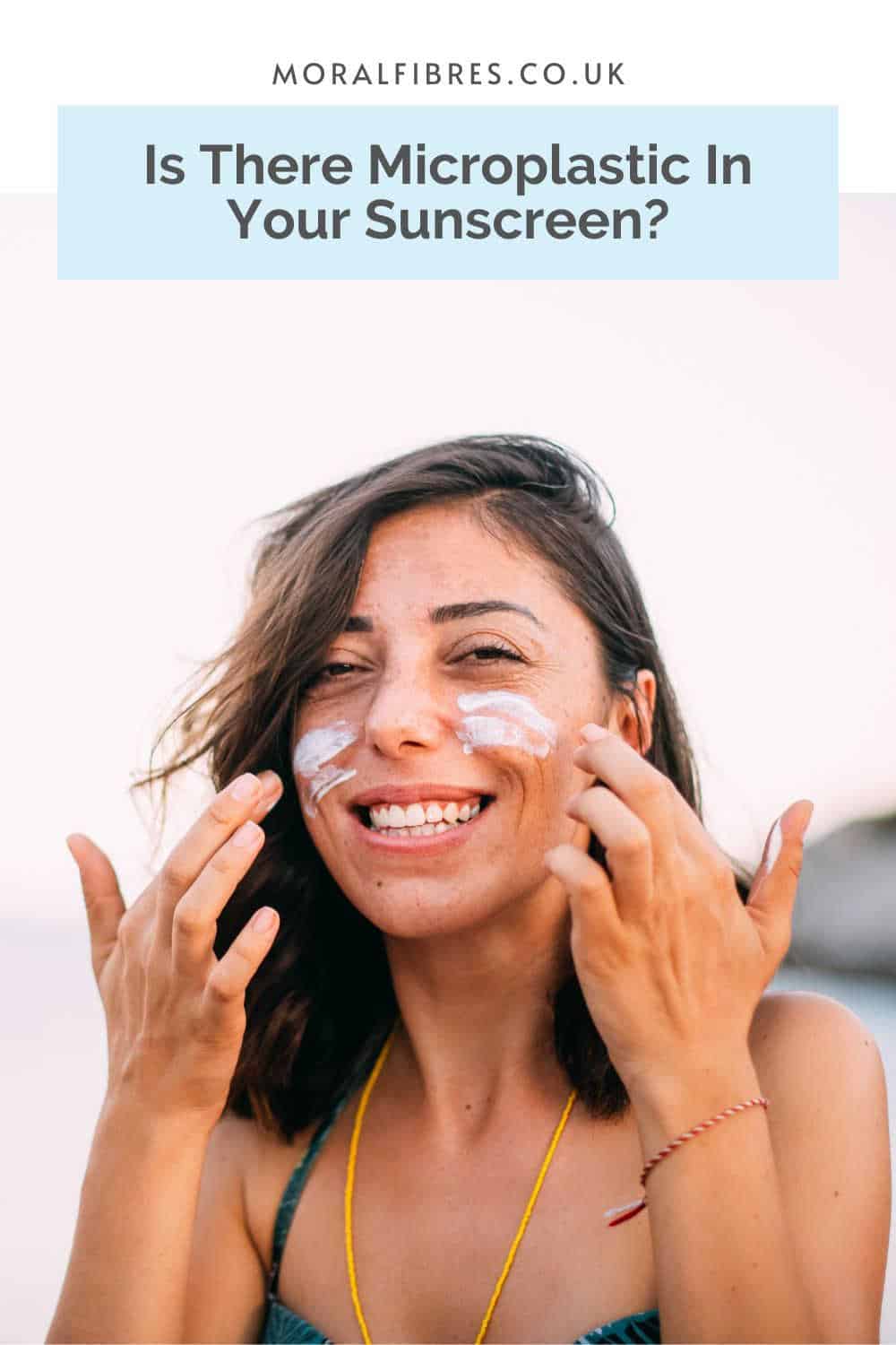 Smiling person on a beach applying sunscreen to their face, with a blue text box that reads does your sunscreen contain microplastic.