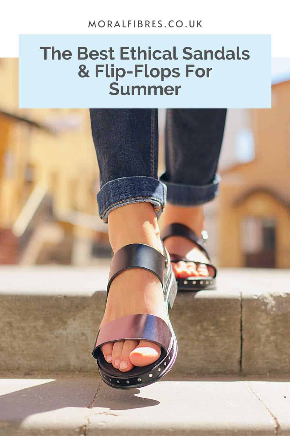 Person walking down a sunny street wearing jeans and black sandals, with a blue text box that reads guide to the best ethical sandals and flip flops.